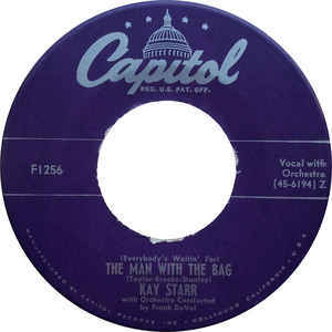 Album cover art for "(Everybody’s Waitin’ for) The Man with the Bag" by Kay Starr