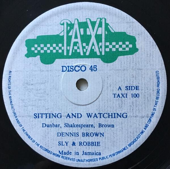 Album cover art for "Sitting And Watching" by Dennis Brown