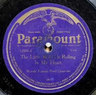 The Little Wheel Is Rolling In My Heart by Wood’s Famous Blind Jubilee Singers