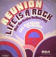 Album cover art for "Life Is a Rock (But the Radio Rolled Me)" by Reunion